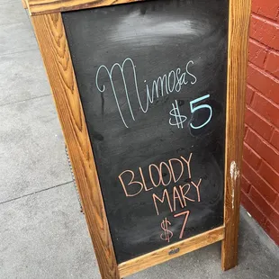 a chalk board with a sign for a bloody mary