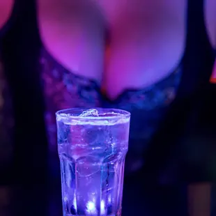 a woman in lingerie and a glass of water