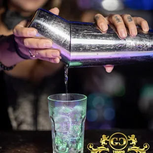 a bartender pouring a drink