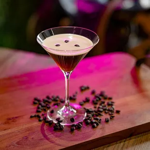 a glass of coffee on a wooden table