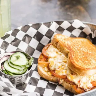 a grilled cheese sandwich and cucumbers