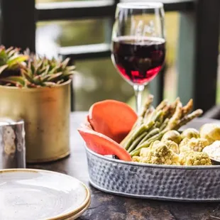 a plate of food and a glass of wine