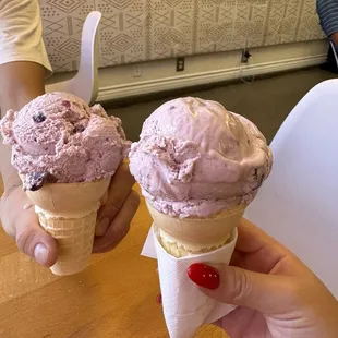 single scoop of huckleberry berry ice cream on a cake cone