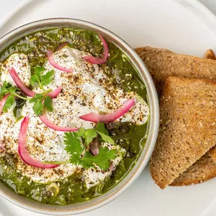 shakshuka + poached egg + tomatillo + spinach + potato
cilantro + dill + za&apos;atar + nine grain toas