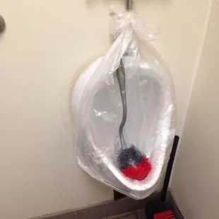 How hard is it to get the only urinal fixed? Probably takes less time than covering it in a trash bag.