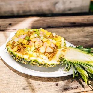 a pineapple with shrimp and rice