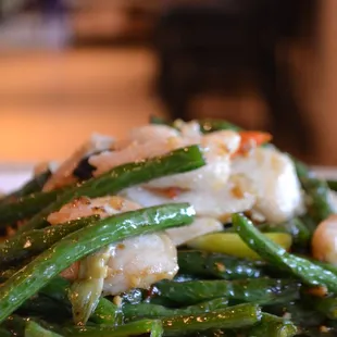 a plate of green beans and shrimp