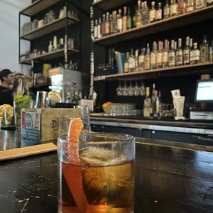 a glass of alcohol on a bar counter