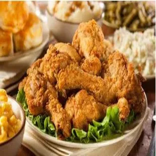 a platter of fried chicken with a side of macaroni and cheese