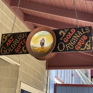 Sign above with mural painted on panning plates