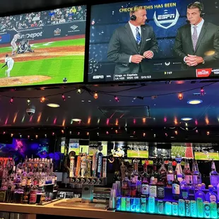 a baseball game being played on tv screens