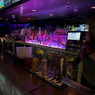 a woman standing at a bar