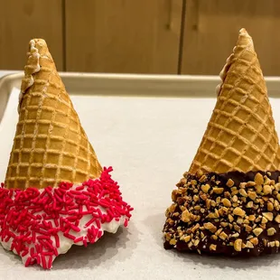 two ice cream cones with sprinkles