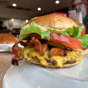 a cheeseburger with bacon and lettuce