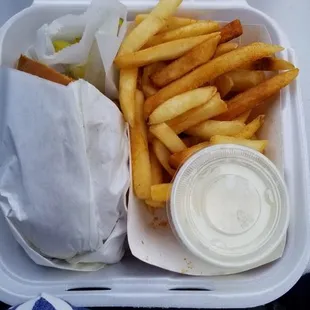 Half of Pastrami sandwich with season fries and ranch dressing