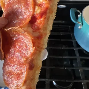 The pizza slice with the plastic baked inside the crust