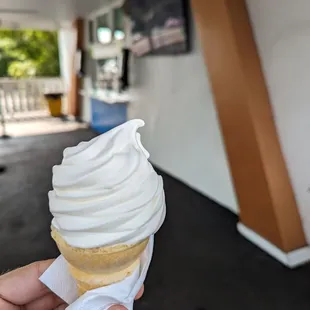 a hand holding an ice cream cone