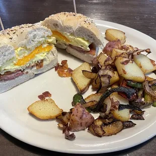 Bacon Egg and Meat on a Bagel, home fries with peppers and onions