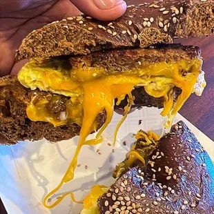 Vegan sausage, egg, and cheddar on a black Russian bagel