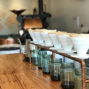 a row of bowls on a wooden table