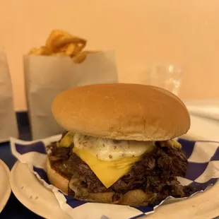 a cheeseburger and fries on a tray