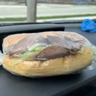 a sandwich wrapped in plastic