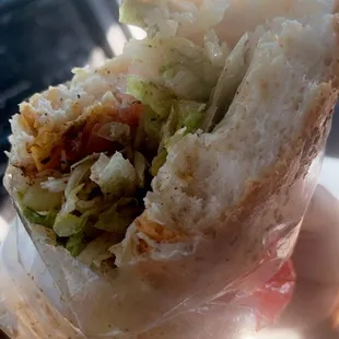 a hand holding a sandwich