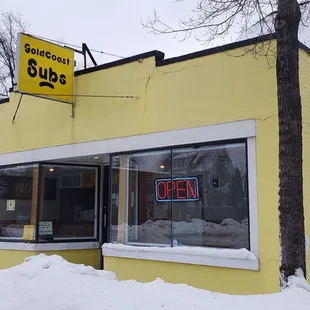 a yellow building on a snowy day