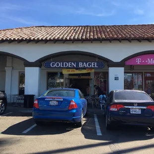 two cars parked in front of the store