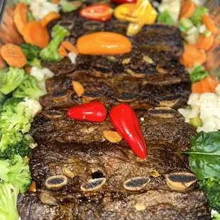 a platter of meat and vegetables