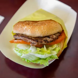 a hamburger with lettuce and tomatoes
