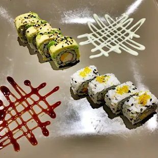 a plate of sushi and sauces