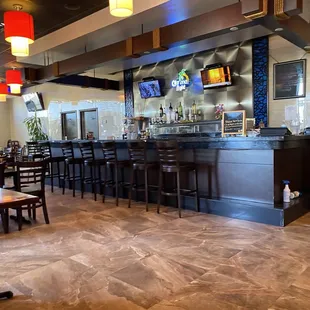 a restaurant with a bar and chairs