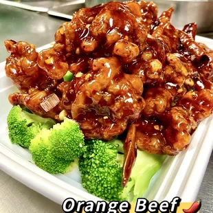 a plate of orange beef and broccoli