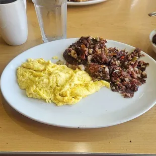 3 eggs,  Homemade Corned Beef Hash, sourdough toast, and fresh fruit