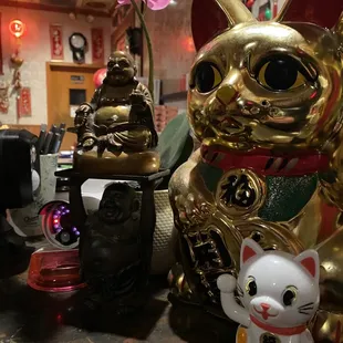 a cat and a cat figurine