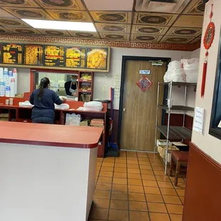 a woman sitting at a counter in a restaurant