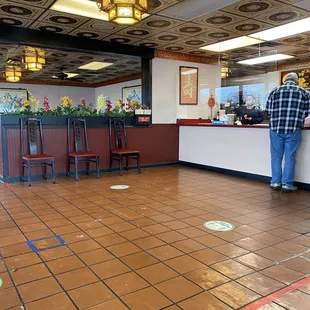 a man standing at a counter in a restaurant