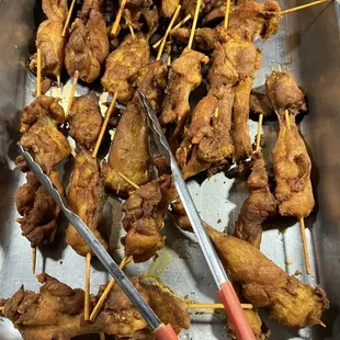 a tray of chicken skewers