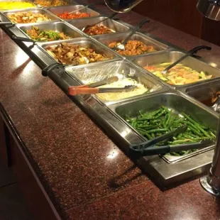 a variety of food in a buffet