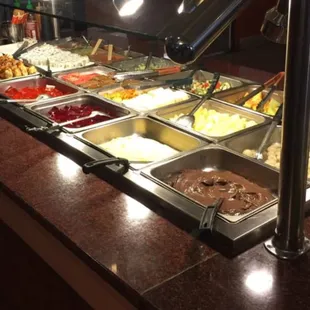 a variety of food in a buffet