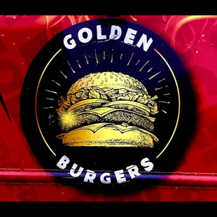 a red truck with a golden burger on it