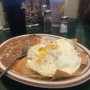 Breakfast green chilaquiles with eggs beans and rice