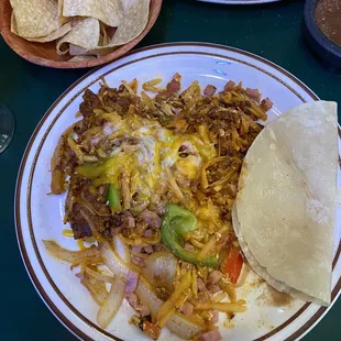 El tornado. Chorizo, ham, eggs, bell pepper, onions, cheese and hash browns. Delicious