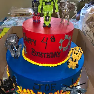 Transformer birthday cake, we ordered the toys my son loves online from amazon and the baker assembled everything how we envisioned.
