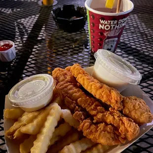 Tenders and fries with a side of white gravy and ranch.