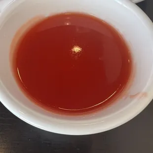 a bowl of tea and a plate of cookies