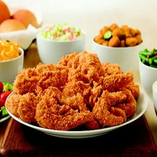 a plate of fried chicken and a bowl of salad