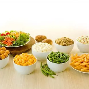 a variety of food in white bowls