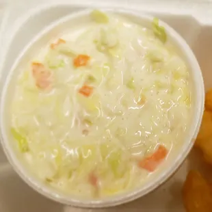 a bowl of soup and a roll